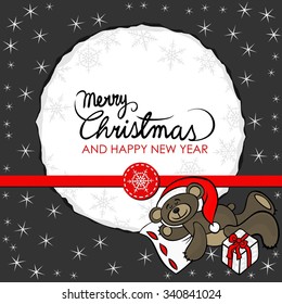 brown toy animal sleeping teddy bear with Santa Claus hat and a gift decorative seasonal Christmas card on dark background with round torn paper with wishes in English