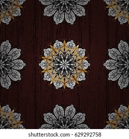 Brown tree with gold trim. Patina. Carving. Element woodcarving. Small depth of field. Furniture in classic style. Pattern on brown background with golden elements. Luxury furniture.