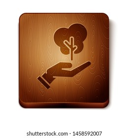 Brown Tree in hand of environmental protection icon isolated on white background. Seed and seedling. Planting sapling. Ecology concept. Wooden square button. Vector Illustration