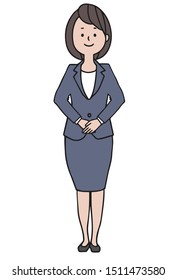 A brown-haired woman in a gray suit stands standing with both hands in front