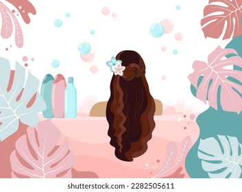 Brunette girl back with flowers in long hair in a bath with foam on a white background with tropical leaves