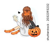 A brunette girl with a rabbit in her hands and an orange pumpkin 
in a witch hat for Halloween