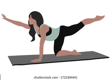 A brunette girl is standing in a pose, doing yoga on a gray rug