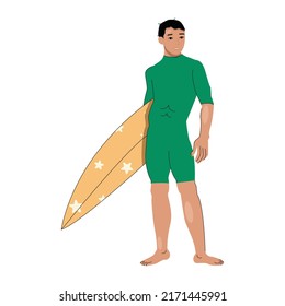 A brunette guy in a swimsuit holds a surfboard in his hands.