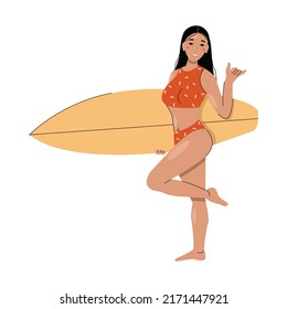 A brunette in a swimsuit holds a surfboard.