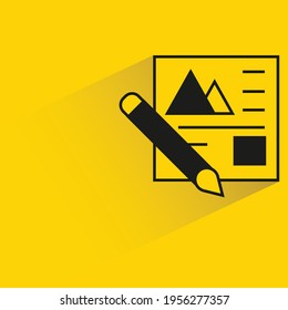 brush and document with shadow on yellow background