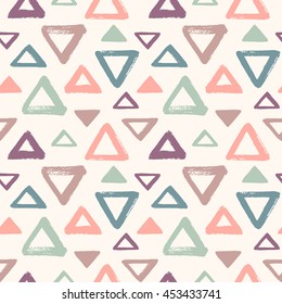 Brush drawn colorful triangles seamless vector pattern. Geometric doodle style background. Abstract hand drawn texture. Various triangle shapes or silhouettes with rough, uneven edges. 
