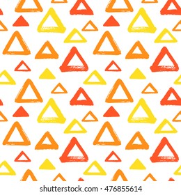 Brush drawn triangles seamless vector pattern. Fire, flame colors. Geometric doodle style background. Abstract hand drawn texture. Various triangle shapes or silhouettes with rough, uneven edges.