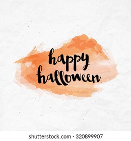 Brush lettering Happy Halloween calligraphy script on watercolor crumpled paper