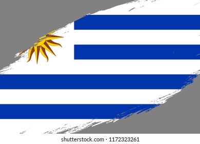 Brush stroke background with Grunge styled flag of Uruguay