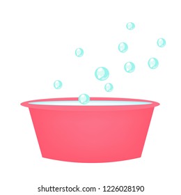 The bubbles of soap are floating over a pink basin.
