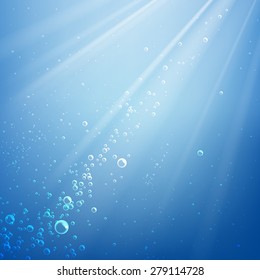Bubbles in the water on a background of light rays
