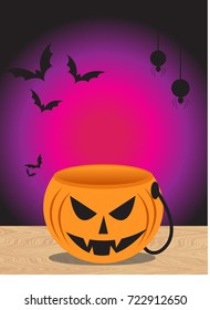 Bucket Pumpkin angry face on wood table and bat spider