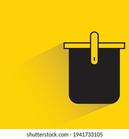 bucket with shadow on yellow background