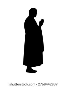 Buddhist monk performing tibetan prayer ritual silhouette