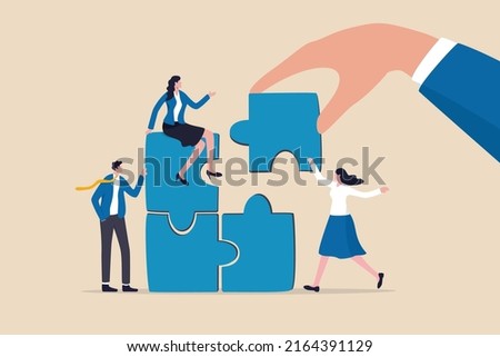 Build your team, leadership to develop teamwork or business partner, cooperate or collaborate for success, assist or help, giant businessman hand connect last jigsaw puzzle to office business team.