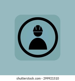 Builder in helmet in circle, in square, on pale blue background