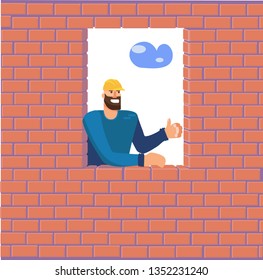 The builder looks out of a window in a brick wall he has completed and rejoices in his work. A man at a construction site lays bricks. Ready wall of a house under construction