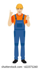 Builder with mobile phone and pointing up. Full length portrait of builder in a flat style. Vector illustration.