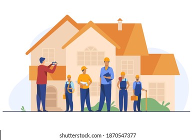 Builders team posing for photo in front of house. Worker, helmet, camera flat vector illustration. Construction or architecture concept for banner, website design or landing web page