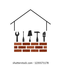 Building and construction concept with house, brick wall and related tools