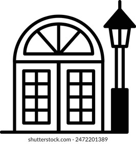 A building with a lamp post in front of it. The building has a lot of windows and a very clean, modern look