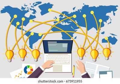 Building online business concept. Workplace and many idea light bulbs from all around the world. Businessman sitting at desk in front of laptop