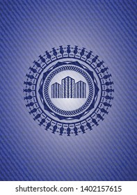 buildings icon inside emblem with denim texture