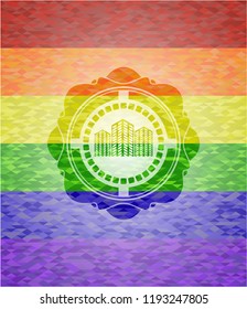 buildings icon inside emblem on mosaic background with the colors of the LGBT flag