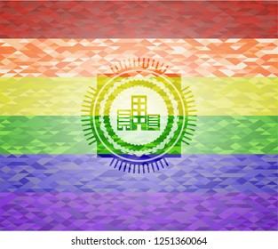 buildings icon inside emblem on mosaic background with the colors of the LGBT flag