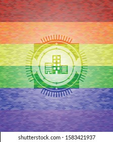 buildings icon inside emblem on mosaic background with the colors of the LGBT flag