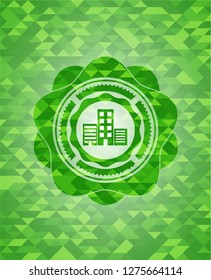 buildings icon inside green emblem with mosaic background