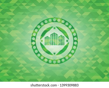 buildings icon inside green emblem with triangle mosaic background