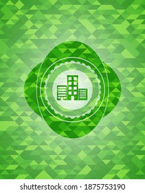 buildings icon inside green mosaic emblem. 