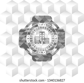 buildings icon inside grey badge with geometric cube white background