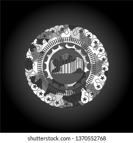 buildings icon inside grey camo emblem