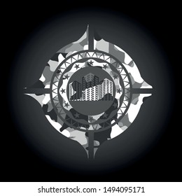 buildings icon inside grey camouflaged emblem