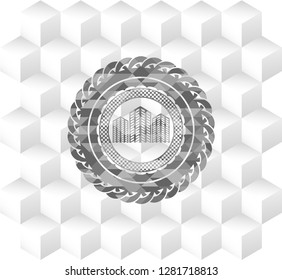 buildings icon inside grey emblem with geometric cube white background