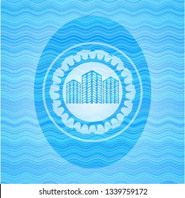 buildings icon inside light blue water badge background.