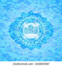 buildings icon inside light blue mosaic emblem. 