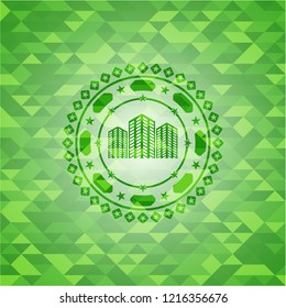 buildings icon inside realistic green mosaic emblem