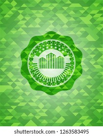 buildings icon inside realistic green mosaic emblem