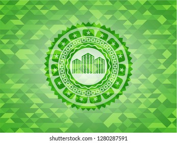 buildings icon inside realistic green mosaic emblem