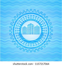 buildings icon inside sky blue water wave style badge.