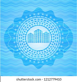 buildings icon inside sky blue water wave badge background.