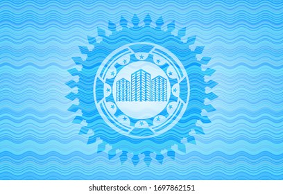 icono de edificios dentro de la insignia de estilo de representación de agua.