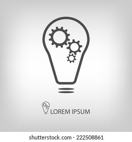 Bulb with gear wheels as logo in grey colors as copyspace