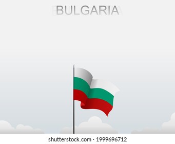 Bulgarian flag flying on a pole standing tall under a white sky