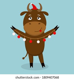 bull symbol of 2021 with a Christmas tree garland in his hands