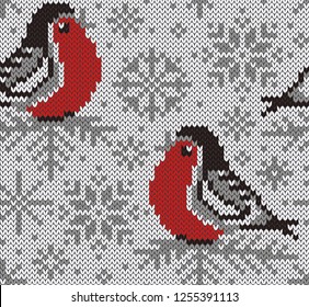 Bullfinch jacquard knitted seamless pattern. Winter snowy background with cute birds and snowflakes. Northern style. Vector illustration.